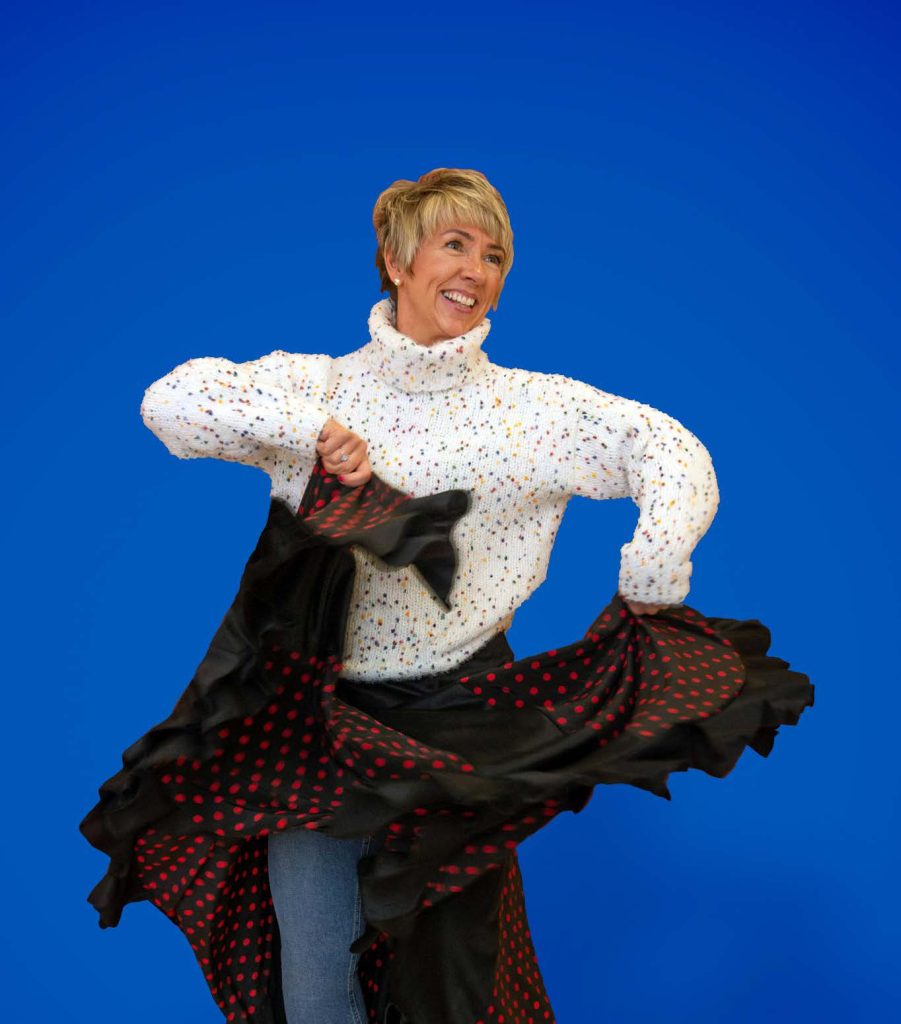 A woman dancing and smiling.